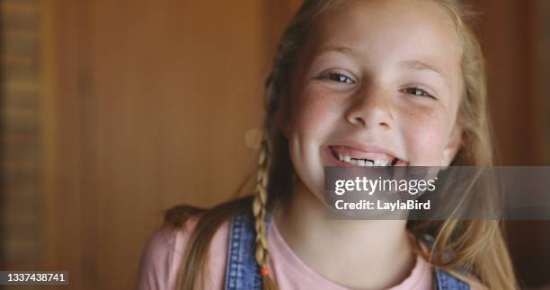 shot of a young girl at home - portrait of a young girl with gappy teeth and blond hair stock pictures, royalty-free photos & images
