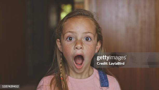shot of a young girl looking shocked - kid shock face stock pictures, royalty-free photos & images