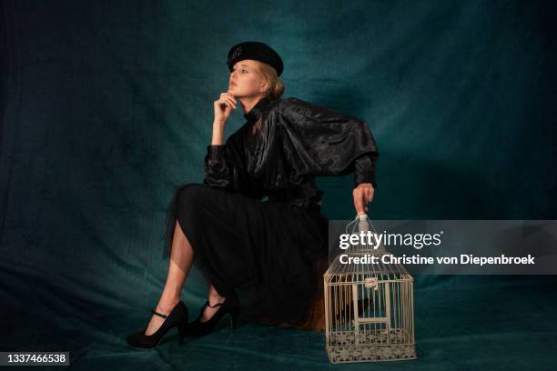 young woman old fashioned with bird cage - the birdcage film stock pictures, royalty-free photos & images