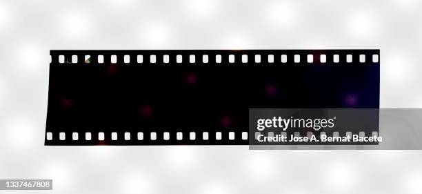 color negative 35mm film strip on a white background. - movie strip stock pictures, royalty-free photos & images