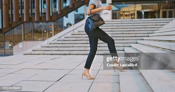 shot of an unrecognisable businesswoman walking up a staircase in the city - latina legs stockfoto's en -beelden