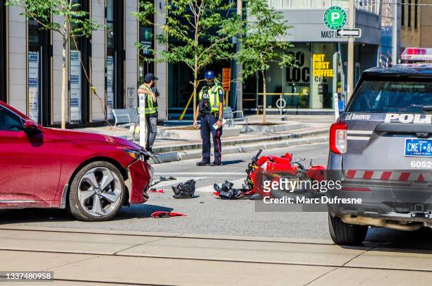 motorcycle hit by car on toronto street during summer day - motorcycle accident stock pictures, royalty-free photos & images