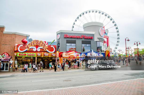 main street of clifton hill in niagara falls - niagara falls canada stock pictures, royalty-free photos & images