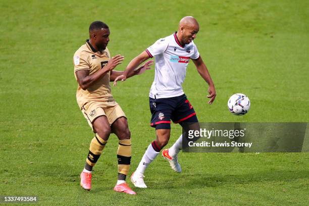 Alex John-Baptiste of Bolton Wanderers battles for possession with David Amoo of Port Vale during the Papa John's Trophy match between Bolton...