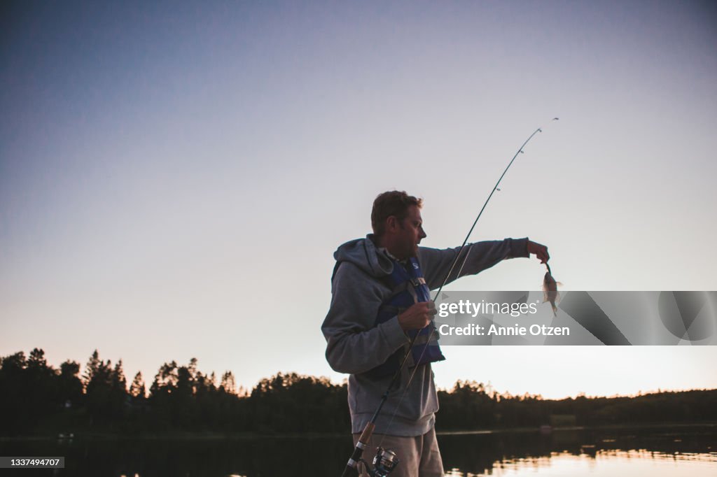 Man Getting Fish Man Catching A Fish High-Res Stock Photo - Getty Images