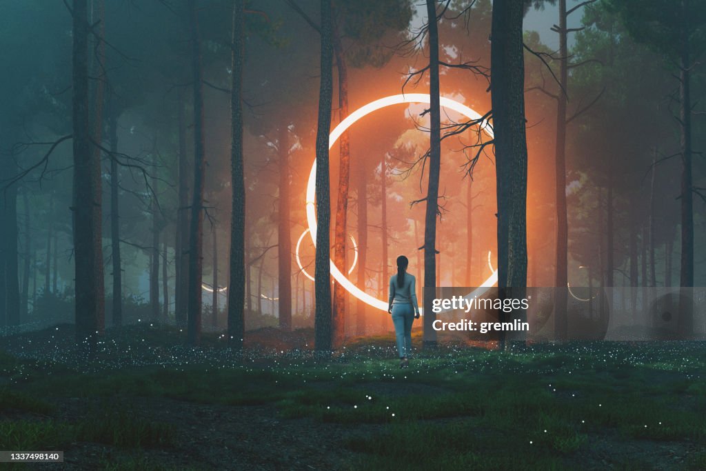 Woman in forest walking towards mysterious object