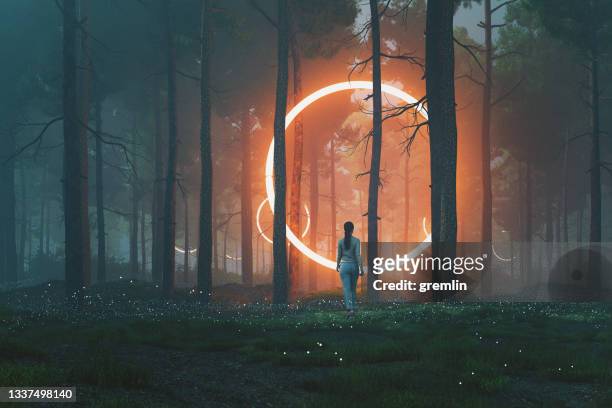 woman in forest walking towards mysterious object - dreamlike stock pictures, royalty-free photos & images
