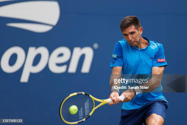 Federico Delbonis of Argentina returns the ball against Denis Shapovalov of Canada during his Men's Singles first round match on Day Two of the 2021...