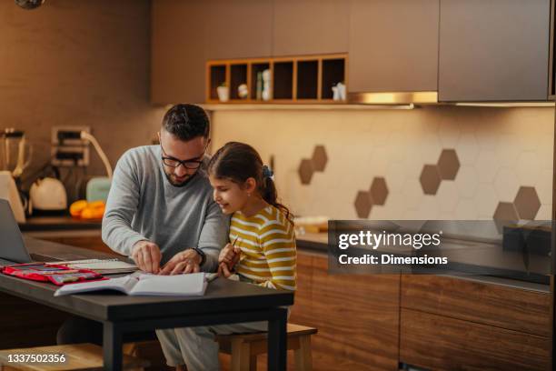 father assisting his child about homework - dad homework stock pictures, royalty-free photos & images