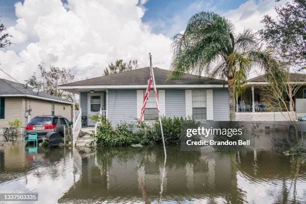 House with an torn American flag is shown on August 31, 2021 in Barataria, Louisiana. Many shops, stores, and services are closed as power throughout...