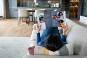 Woman relaxing at home reading a magazine