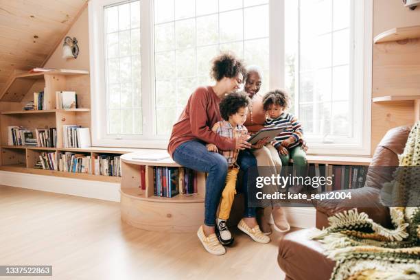 family watching cartoons on a tablet - cottage family stock pictures, royalty-free photos & images