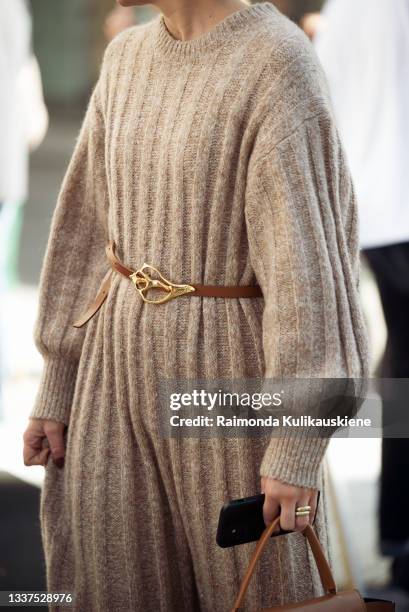 Guest wearing beige knitted long dress, light brown bag and black high heels during Stockholm fashion week Spring/Summer 2022 on August 31, 2021 in...