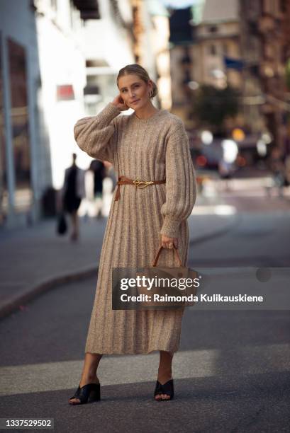 Guest wearing beige knitted long dress, light brown bag and black high heels during Stockholm fashion week Spring/Summer 2022 on August 31, 2021 in...