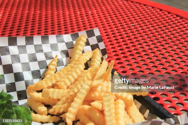outdoor picnic table with french fries on tray - scalloped stock pictures, royalty-free photos & images