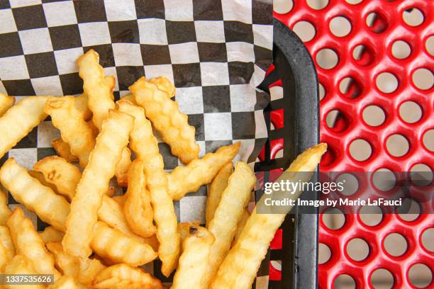 close-up of french fries in a basket - scalloped stock pictures, royalty-free photos & images