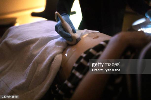 pregnant woman having ultrasound done - doppler ultrasound stock pictures, royalty-free photos & images