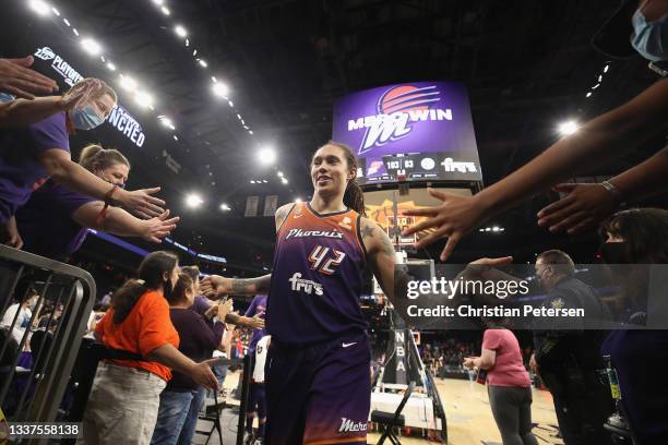 Brittney Griner of the Phoenix Mercury high fives fans following the WNBA game against the Chicago Sky at the Footprint Center on August 31, 2021 in...