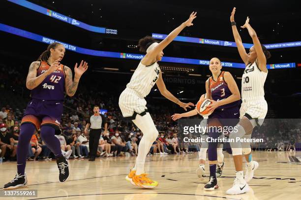 Diana Taurasi of the Phoenix Mercury drives the ball against Candace Parker and Azurá Stevens of the Chicago Sky during the second half of the WNBA...