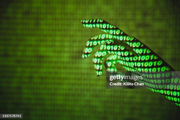 robotic hand reaching out for something with binary code binary matrix projected on it - deep learning stock pictures, royalty-free photos & images