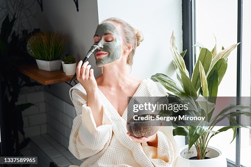 Woman enjoying skin care treatment at home Woman enjoying skin care treatment at home