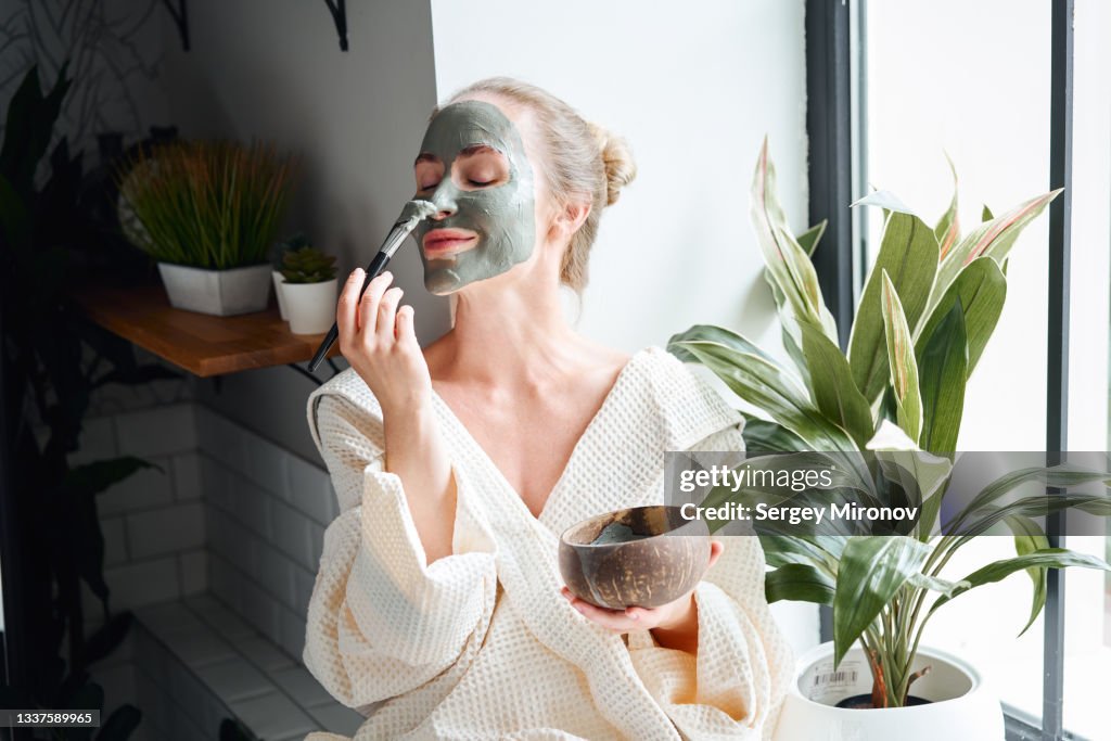 Woman enjoying skin care treatment at home
