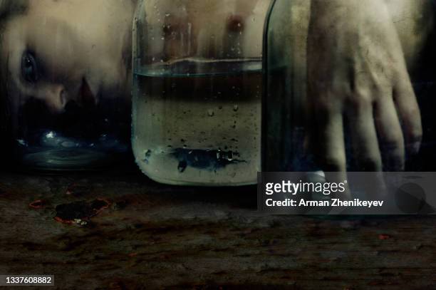 naked woman looking through glass jars with water - dead body in water fotografías e imágenes de stock