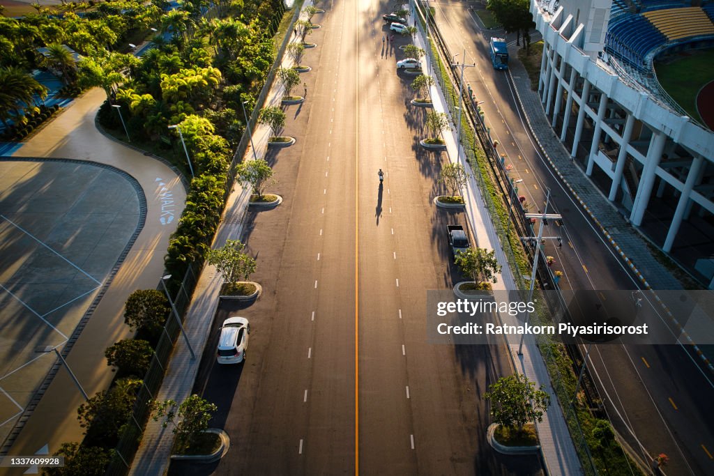 Aerial Drone View of Shadow of Man Ride Motorcycle on Road at Morning