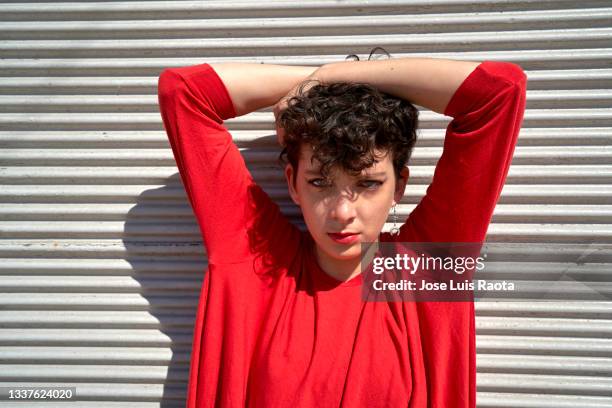 portrait woman standing behind the door - red shorts stock pictures, royalty-free photos & images