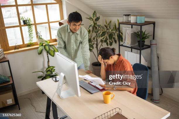 business colleagues arguing about work in office - employee conflict stock pictures, royalty-free photos & images