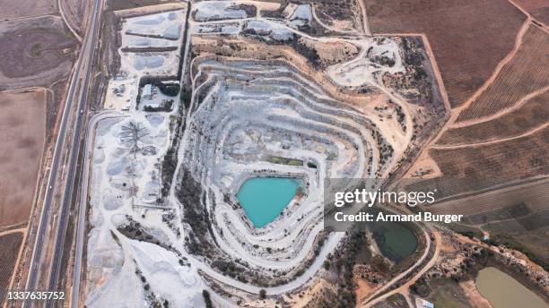 high angle shot of snowy excavation site along a dry and arid landscape - south africa mining stock pictures, royalty-free photos & images