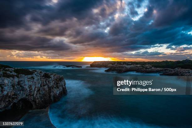 scenic view of sea against dramatic sky during sunset,spain - baron beach stock pictures, royalty-free photos & images