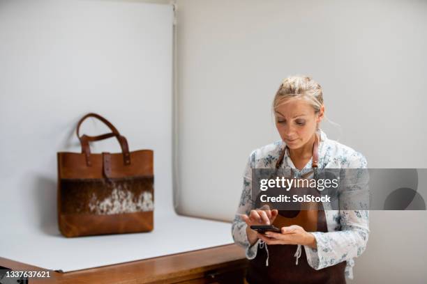 preparing to photograph her product - leather craft stock pictures, royalty-free photos & images