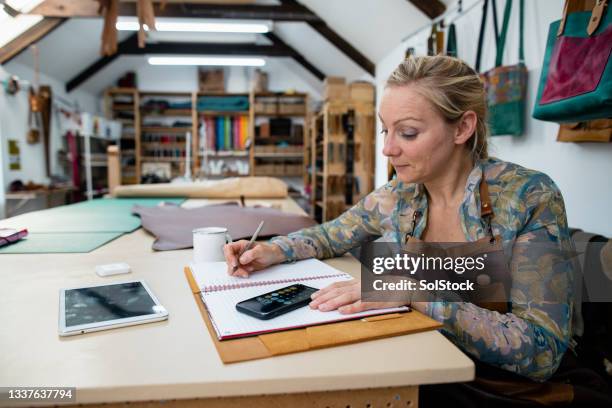 keeping her books updated - writing instrument bildbanksfoton och bilder