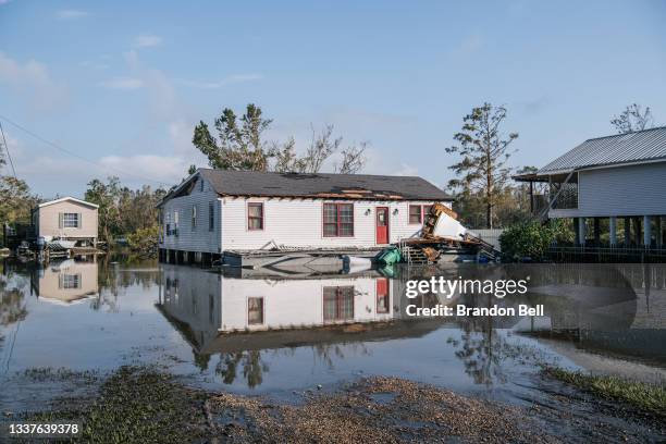 Floodwater surrounds houses on September 01, 2021 in Jean Lafitte, Louisiana. Jean Lafitte Mayor Tim Kerner has pleaded for help for residents of the...