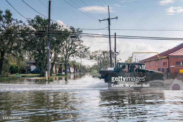 Members of the National Guard drive through floodwater on September 01, 2021 in Jean Lafitte, Louisiana. Jean Lafitte Mayor Tim Kerner has pleaded...