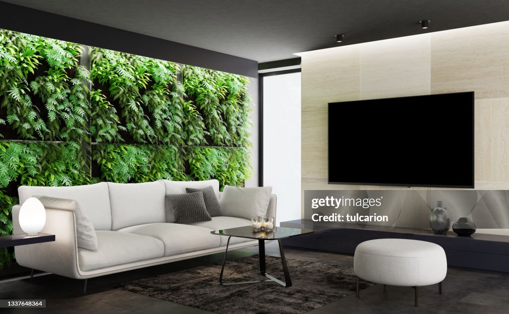 Modernes minimalistisches Apartment-Interieur. Wohnzimmer mit vertikaler Gartengrüne Pflanzenwand. Fernsehraum.