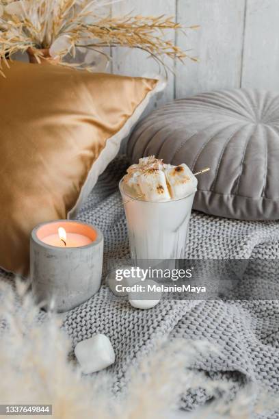 cozy marshmallow milkshake on sofa with candle - candle overhead stock pictures, royalty-free photos & images