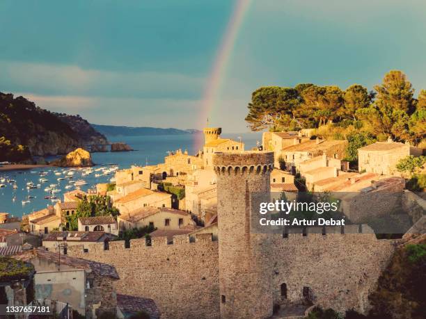 beautiful rainbow after the rain in the iconic tossa de mar in the catalan costa brava coast. vista de un espectacular arco iris con el pueblo amurallado de tossa de mar. - tossa de mar bildbanksfoton och bilder