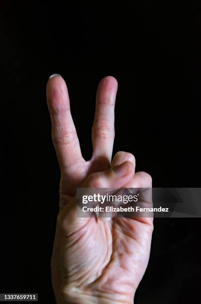 woman hand showing peace sign - two fingers stock pictures, royalty-free photos & images