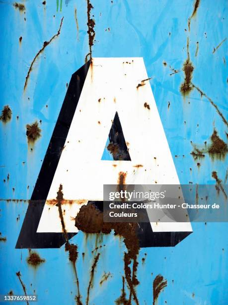 letter a painted on a rusty metal plate in brussels - blue plate stock pictures, royalty-free photos & images