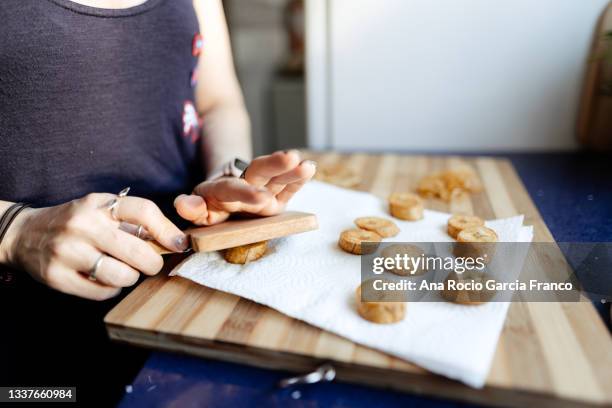 cooking cuban tostones. male green banana fried - puerto rican culture stock pictures, royalty-free photos & images