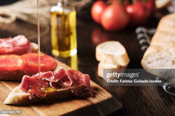 breakfast with bread, tomato, ham and oils - tomato bread stock pictures, royalty-free photos & images
