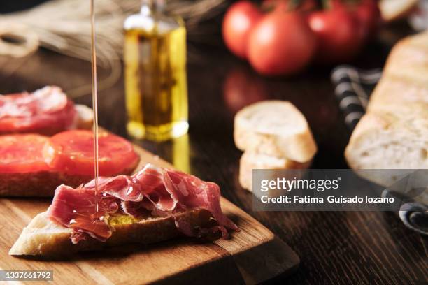 breakfast with bread, tomato, ham and oils - appetizers imagens e fotografias de stock