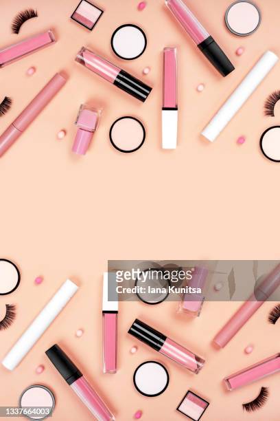 set of different pink makeup accessories on beige, brown background. cosmetic products for skin care. eyeshadow, blush, face powder, nail polish, mascara, eyelashes, lipstick. copy space. vertical. - combinação cor de pele imagens e fotografias de stock