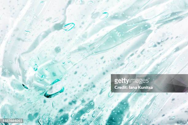 transparent blue moisture serum for face smudged. hydrating hyaluronic acid. antibacterial gel with bubbles. cosmetic products for makeup and skin care. cosmetology. - make up liquid stock pictures, royalty-free photos & images