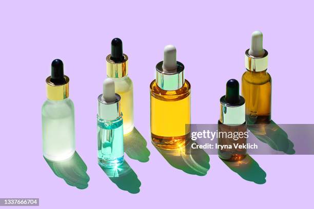 trendy beauty concept of facial serum, natural essential oil and perfume in cosmetic bottles. - cosmetic products stock pictures, royalty-free photos & images