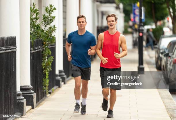 friends running in london - sport community center stock pictures, royalty-free photos & images