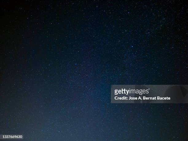full frame of black night sky with stars. - clear sky photos et images de collection