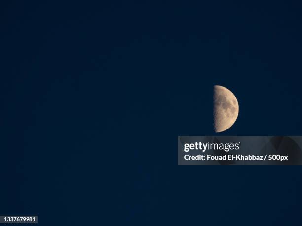 low angle view of moon against clear sky at night,montreal,canada - fouad el khabbaz stockfoto's en -beelden